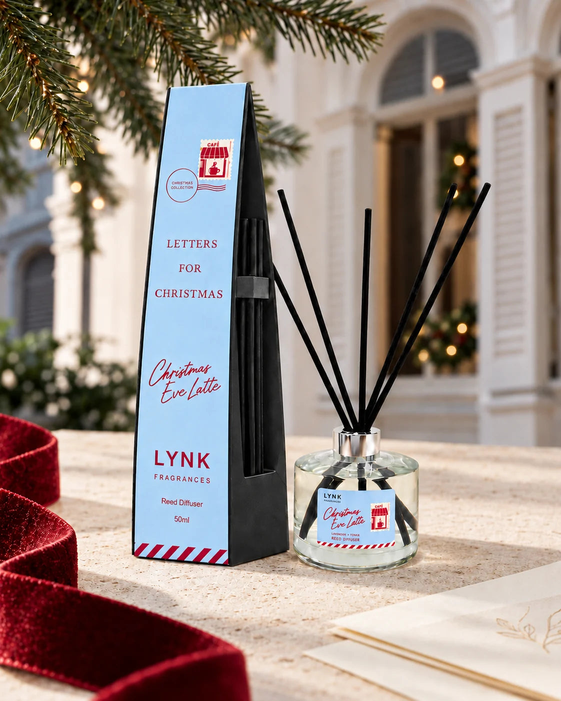 Christmas Eve Latte reed diffuser in a festive Christmas still life
